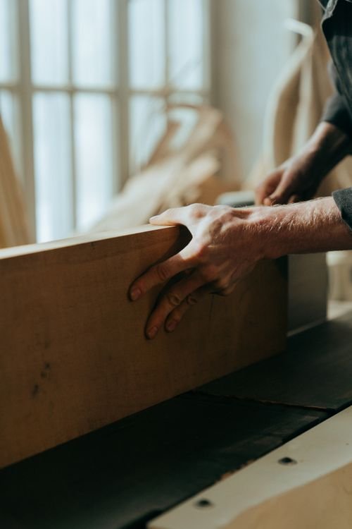 Craftsman's hands carving and shaping wood