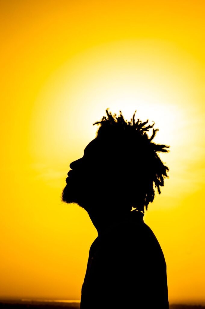 Golden silhouette of a person against a glowing sky