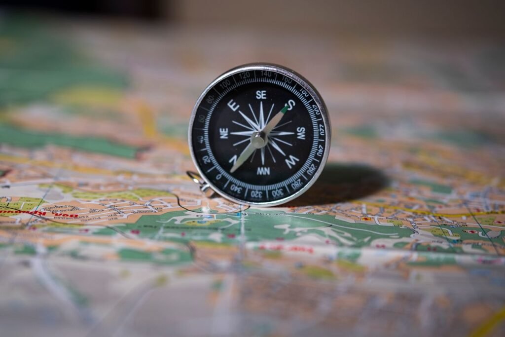 Vintage compass resting on old maps